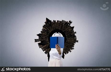 Woman hiding face behind book. Unrecognizable woman with opened book against her face