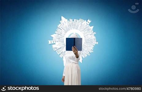 Woman hiding face behind book. Woman with opened book against her face