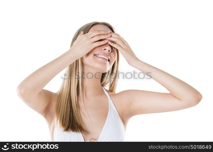Woman hiding her eyes with hands and smiling isolated on white background