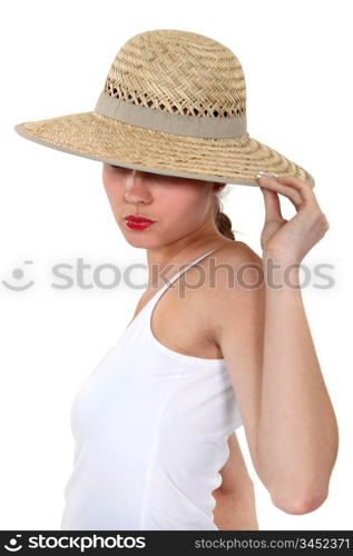 Woman hiding her face under a wide-brimmed hat