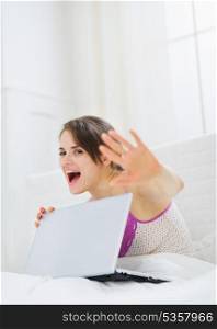 Woman hiding what she doing on laptop