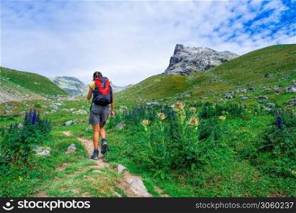 Woman hiker on a mountain trail
