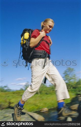 Woman hiking outdoors in scenic location (blur)