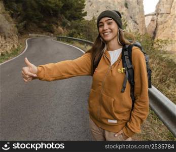 woman hitch hiking car mountains