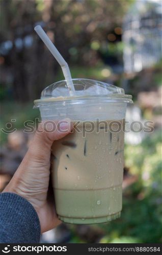 Woman hold her iced coffee, stock photo