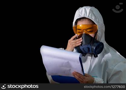 Woman hold report file folder in white chemical protective clothing and antigas mask with yellow glasses at black background, Women scientist in safety suit, Safety virus infection concept, pollution protect face masking