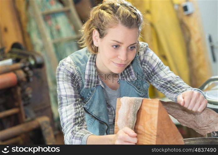 woman hold the sanding paper with wood block