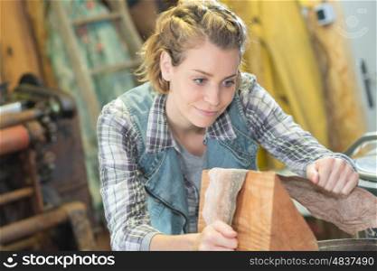 woman hold the sanding paper with wood block