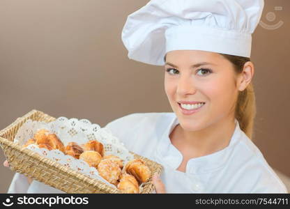 Woman holding a basket of choux pastry