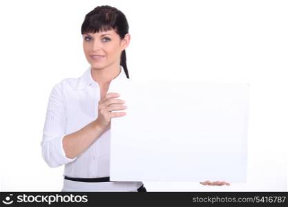 Woman holding a board left blank for your message