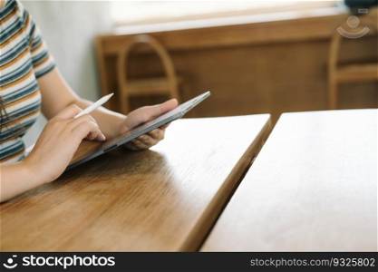 Woman holding a book device reading on e-book on digital tablet device or social media apps online ecommerce