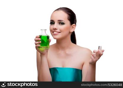 Woman holding a bottle of green perfume