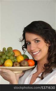 Woman holding a bowl of fruit