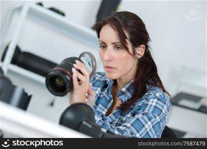 woman holding a camera lens