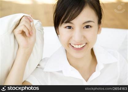 Woman holding a cushion with hand
