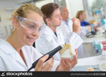 woman holding a fake denture