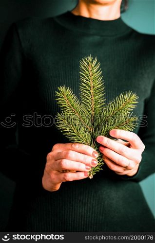 woman holding a fir branch at Christmas