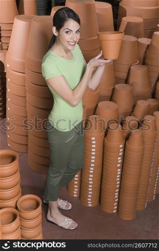 Woman holding a flower pot in a garden center