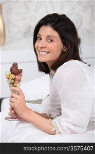 woman holding a glass full with Easter chocolate eggs