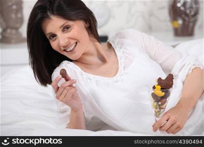 woman holding a glass full with Easter eggs