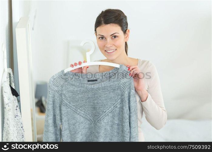woman holding a grey pullover