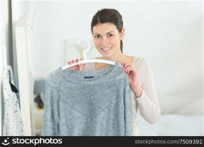 woman holding a grey pullover