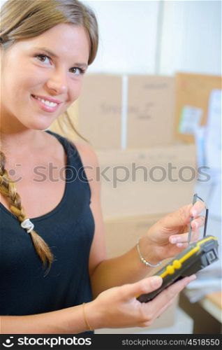 woman holding a hand-held inventory gadget