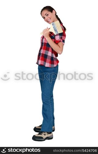 Woman holding a large paintbrush
