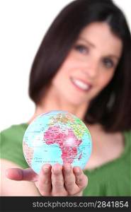 Woman holding a mini-globe