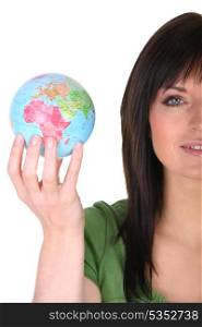 Woman holding a mini globe