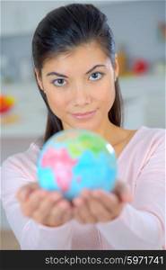 Woman holding a miniature globe