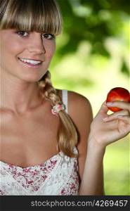 Woman holding a nectarine