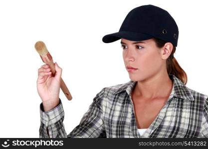 Woman holding a paintbrush
