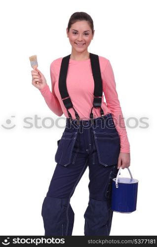 Woman holding a paintbrush and can of paint