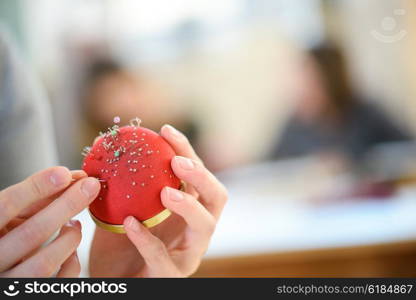 Woman holding a pin cushion