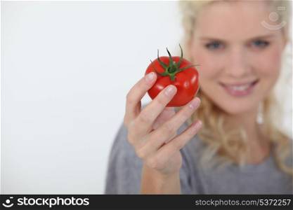 Woman holding a tomato