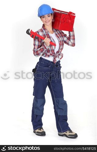 Woman holding a toolbox and a pipe wrench