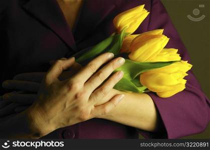 Woman Holding an Armful of Tulips