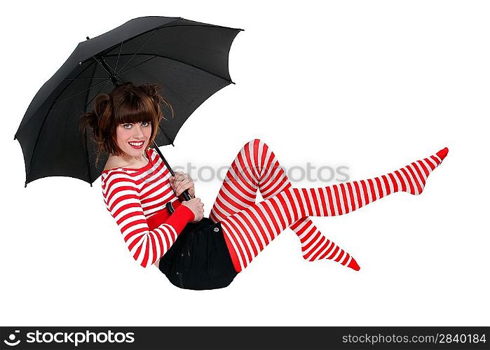 Woman holding an umbrella and floating in the air