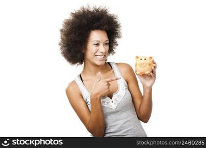 Woman holding and pointing to a piggy bank