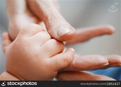 Woman Holding Baby&acute;s Hand