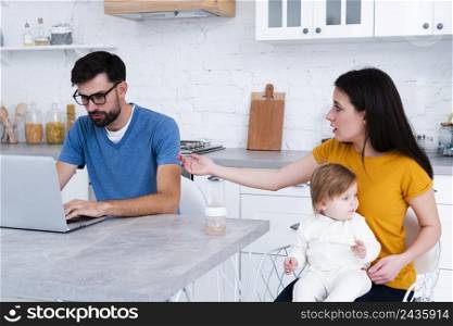 woman holding baby angry with man