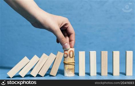 woman holding bank notes fallen pieces wood