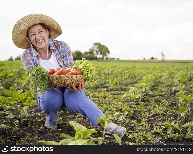 woman holding basket full vegetables with copy space