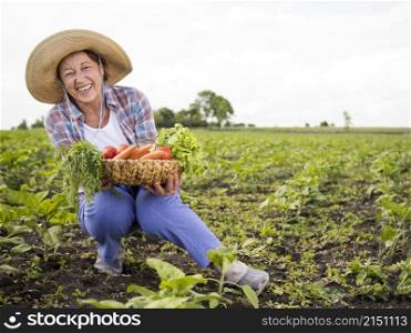 woman holding basket full vegetables with copy space