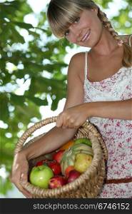 Woman holding basket of fruit