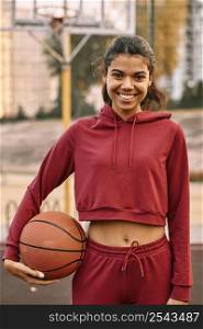 woman holding basketball outdoors 2