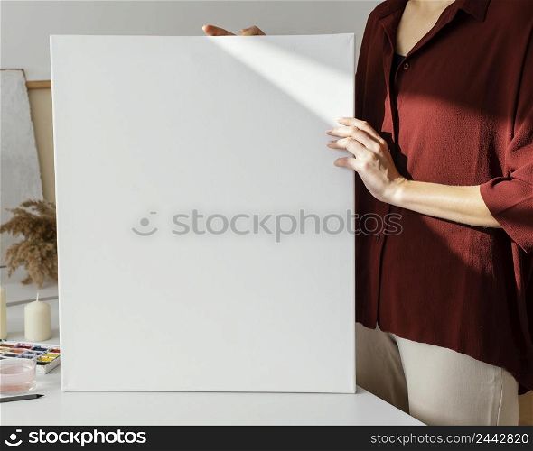 woman holding blank canvas 2