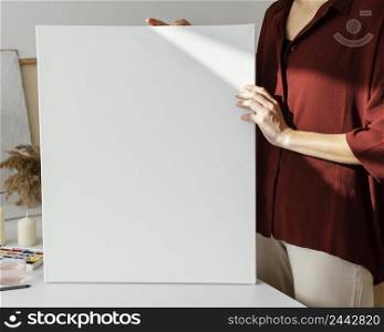 woman holding blank canvas 2