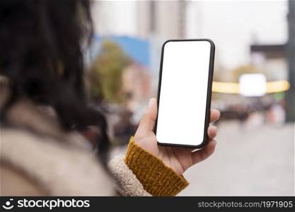 woman holding blank smartphone outside. High resolution photo. woman holding blank smartphone outside. High quality photo